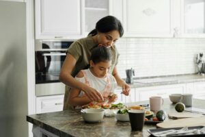 daughter and mother preparing a healthy breakfast after learning that diet is important for oral health from their dentist Round Rock