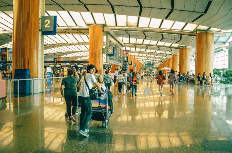 teen boy in the airport rolling luggage after visiting orthodontist Round Rock for Invisalign